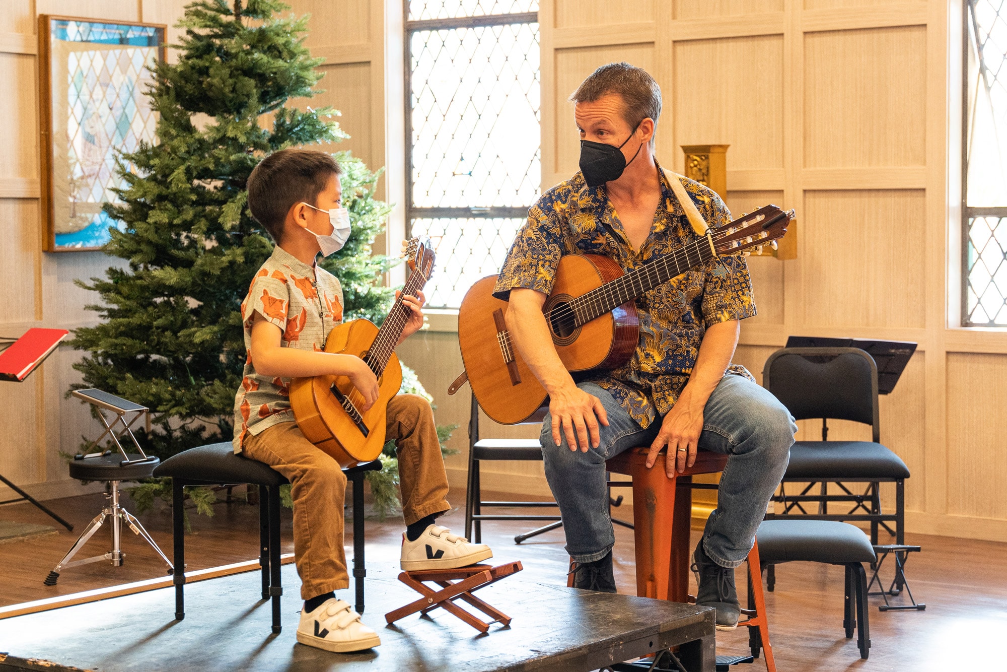 Felix talking with a guitar student